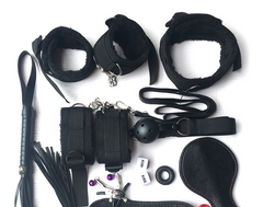 Collection of black restraining devices and accessories on a white background