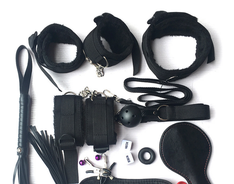 Collection of black restraining devices and accessories on a white background